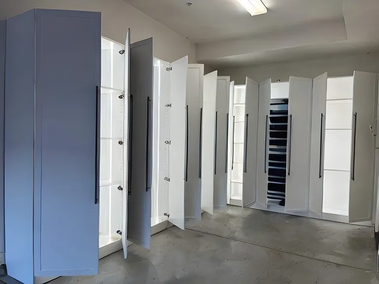 White closet towers with hinged doors open showing adjustable shelves
