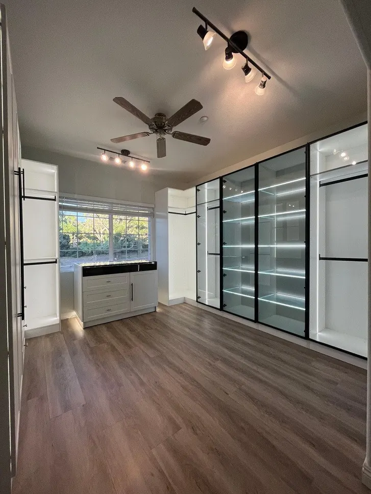 Assembled white closet suite with island, glass tower and ceiling cabinets